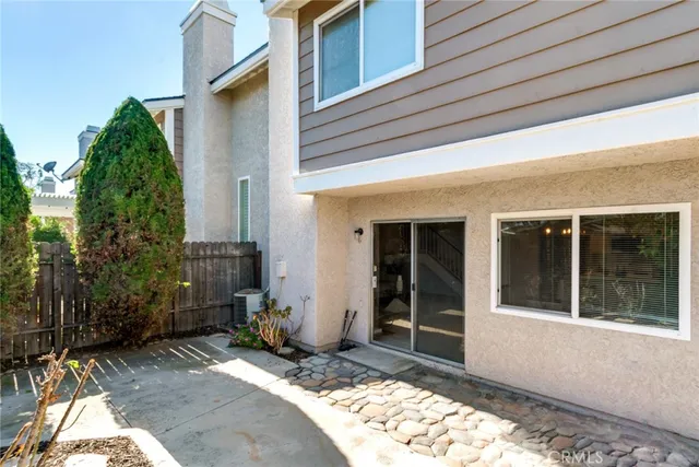 a backyard of a house with table and chairs