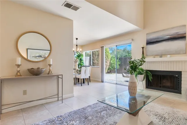 a living room with furniture a fireplace and a large window