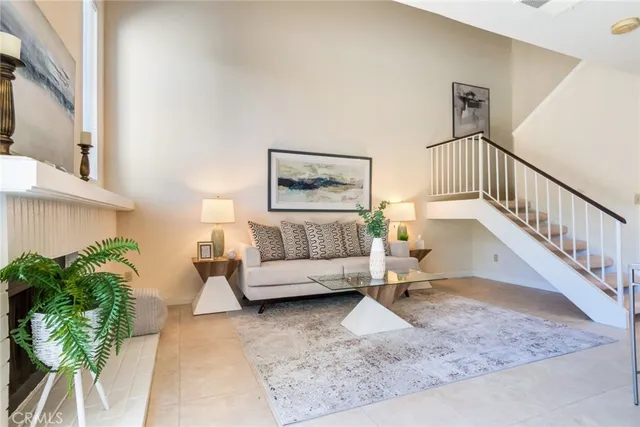 a living room with furniture and a potted plant