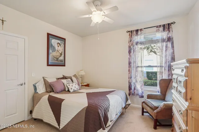 a bedroom with a bed couch and a window