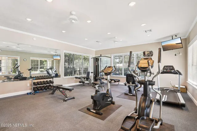 a living room with patio furniture and a floor to ceiling window