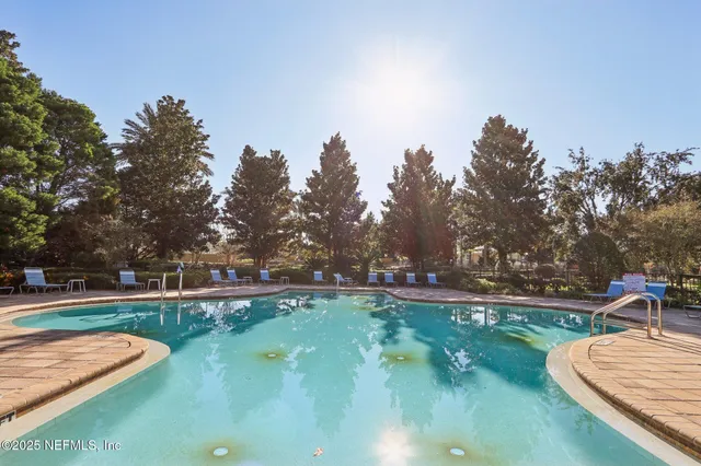 a front view of a house with a yard and potted plants