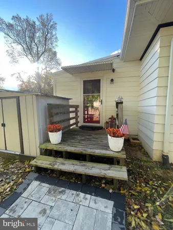 a view of a back yard of the house with a chair