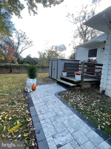 a backyard of a house with barbeque oven table and chairs