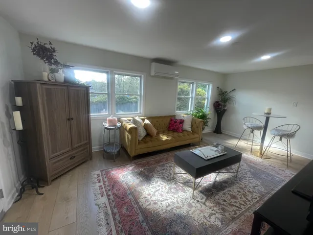 a living room with furniture rug and window