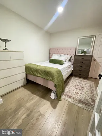 a bedroom with a bed and a mirror