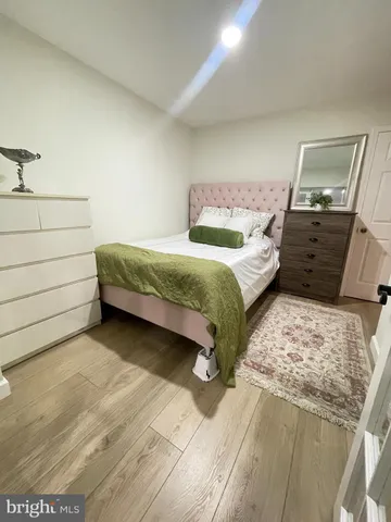 a bedroom with a bed and a mirror