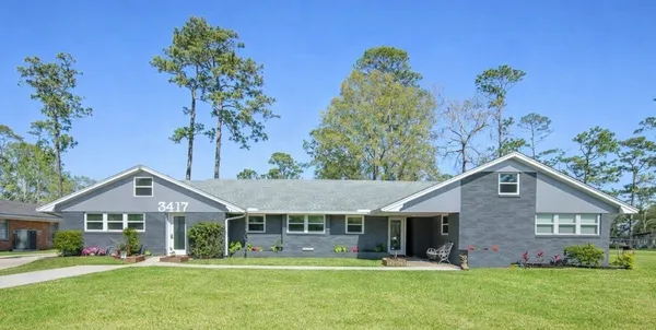 a view of a backyard with sitting area