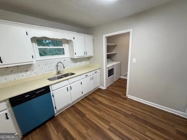 a kitchen with a sink cabinets and window