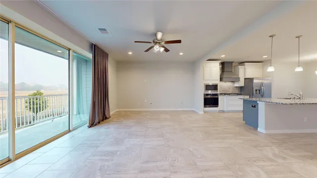 a view of a kitchen with a sink and refrigerator