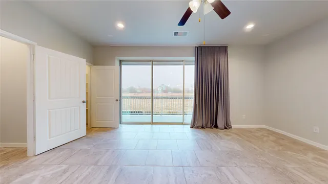 an empty room with closet and windows