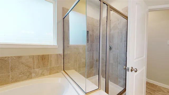 a bathroom with a bathtub and a shower