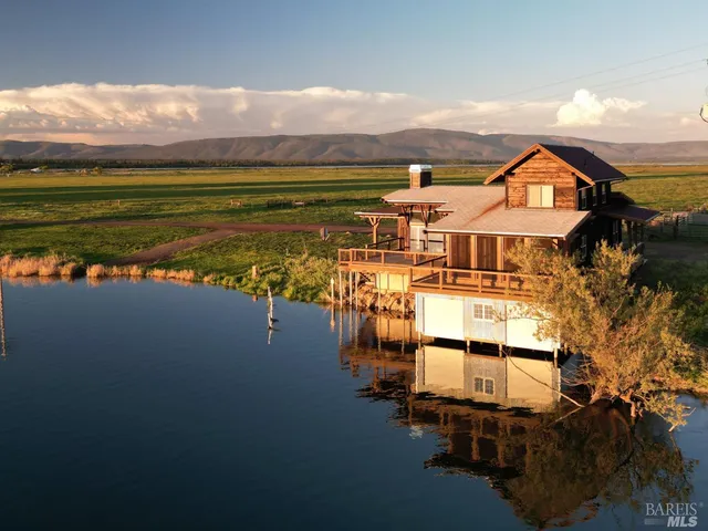 a living room with furniture large window and a fireplace