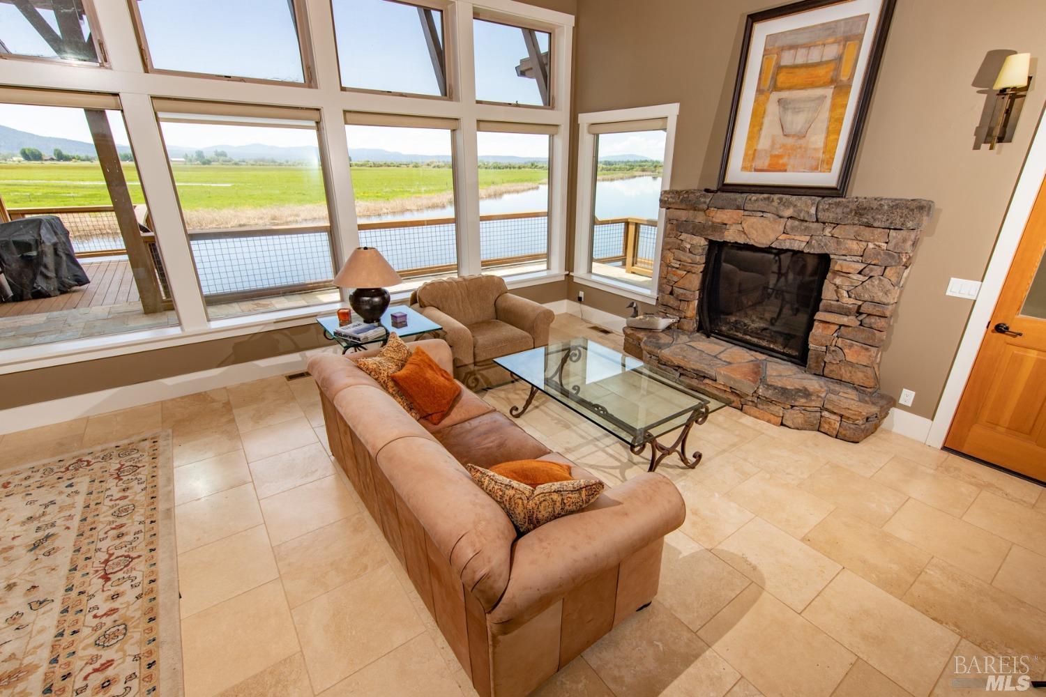 42369 Horr Road Fall River Mills, CA 96028 - Photo 23 of 43 a living room with furniture large window and a fireplace