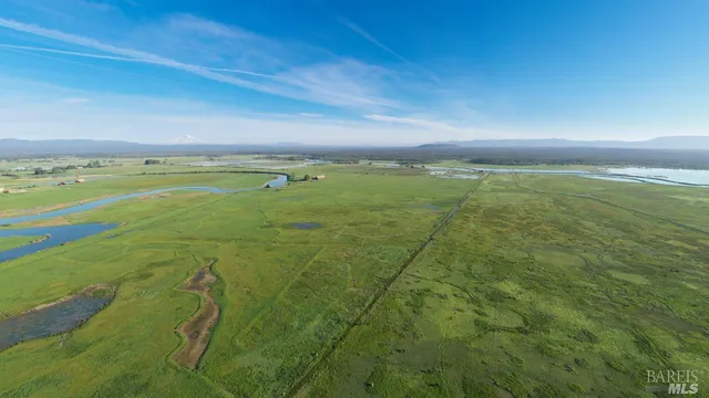 a view of ocean and a yard