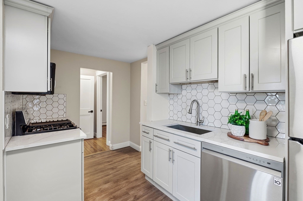 99 Mason Street, Unit 2 Salem, MA 01970 - Photo 8 of 25 a kitchen with stainless steel appliances granite countertop a sink stove and cabinets