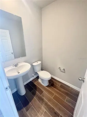 a bathroom with a sink toilet and a mirror