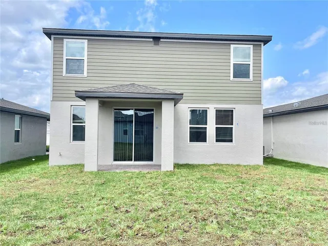 a view of house with yard