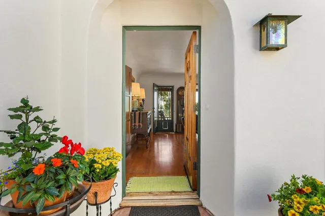 a dining room with furniture a chandelier and wooden floor