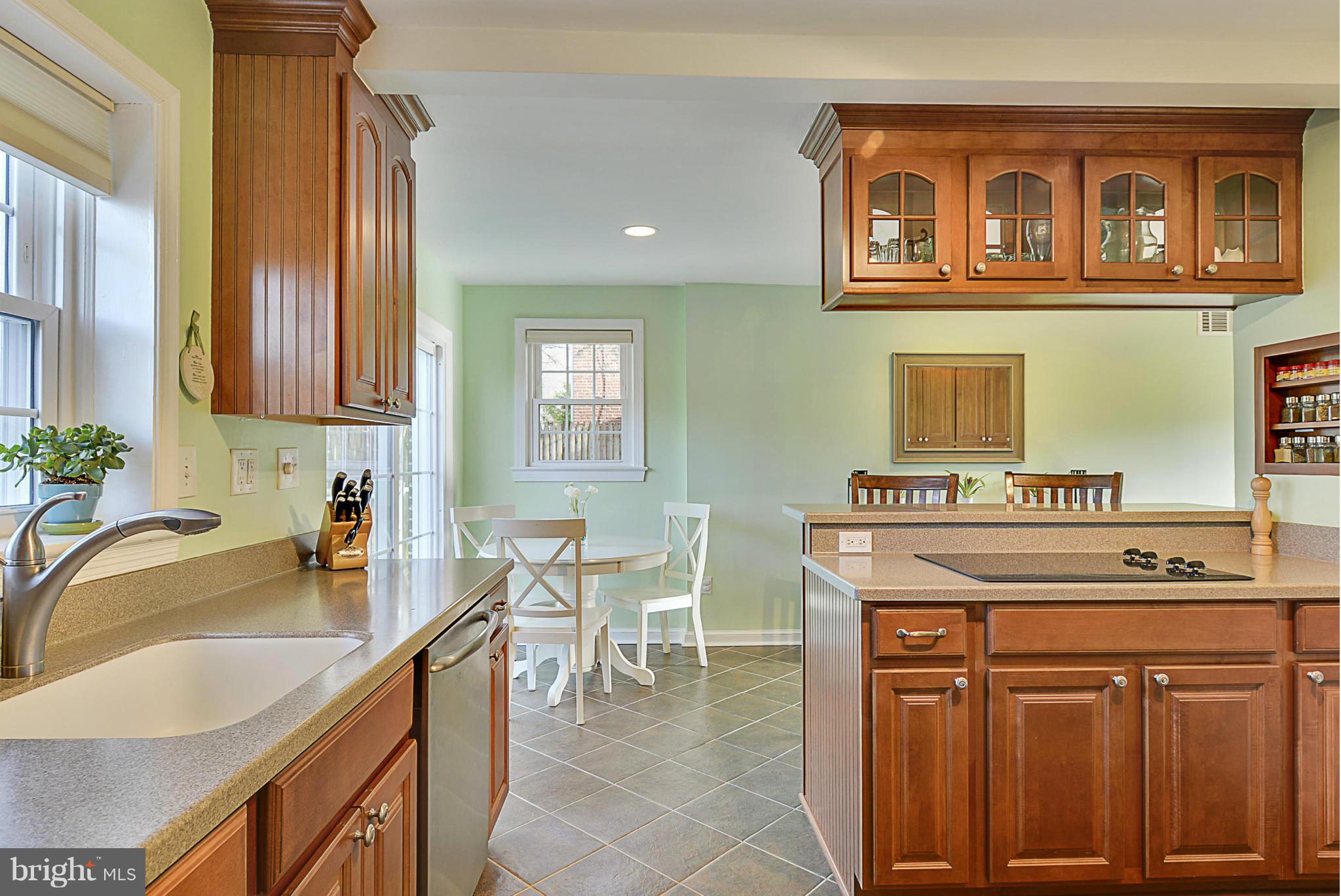 9616 Flower Avenue Silver Spring, MD 20901 - Photo 14 of 30 Kitchen peninsula with glass front cabinets.