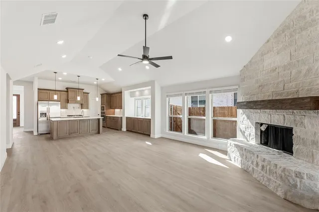 a view of a big room with windows and fireplace