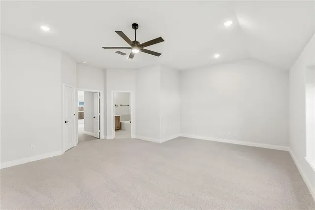 an empty room with a ceiling fan and a window