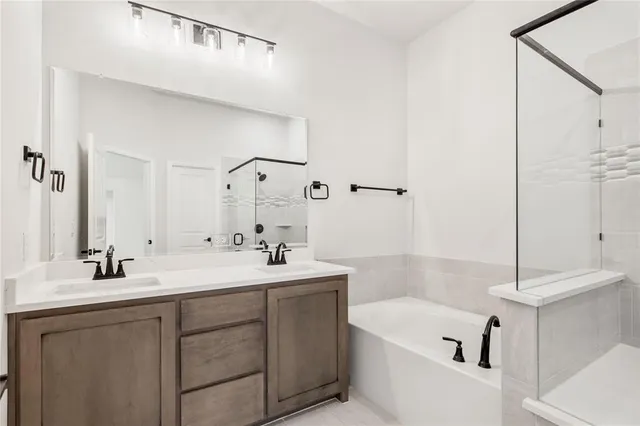 a bathroom with a tub a sink and mirror