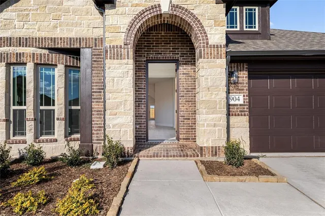 a view of a brick house with large windows