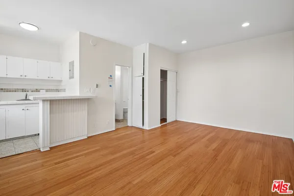 a view of a kitchen with wooden floor