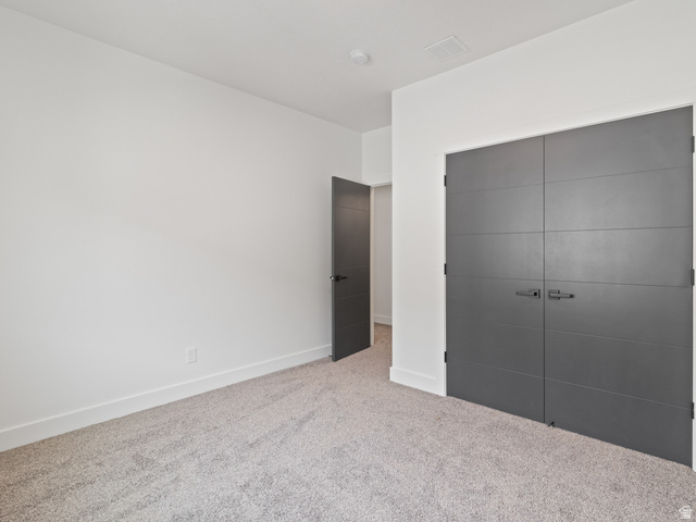 130 East 7085th South, Unit 3 Midvale, UT 84047 - Photo 14 of 30 Unfurnished bedroom with a closet and carpet flooring