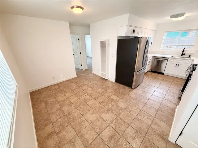 a kitchen with a refrigerator and a stove
