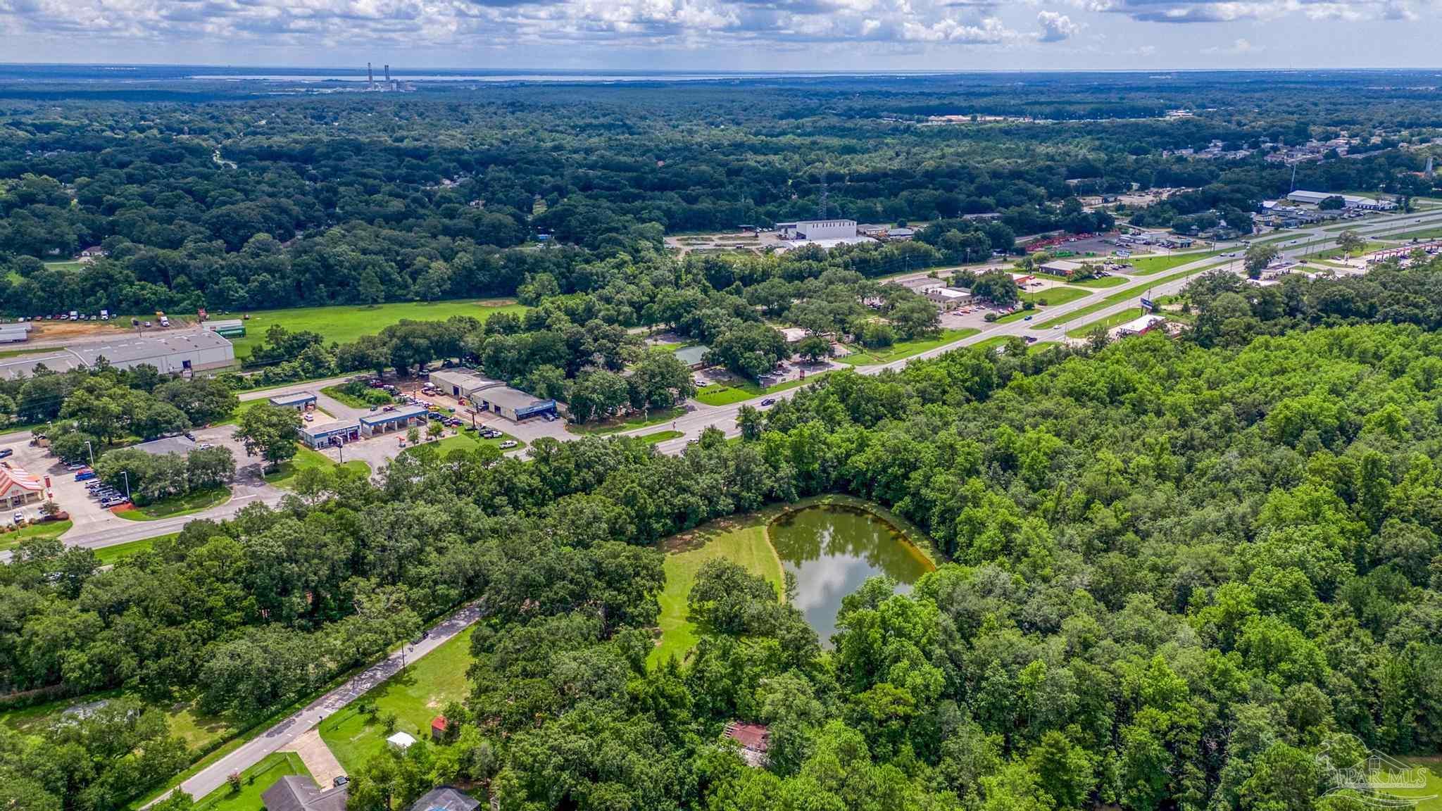 2345 Pompano Street Cantonment, FL 32533 - Photo 31 of 48 an aerial view of residential houses with outdoor space and swimming pool
