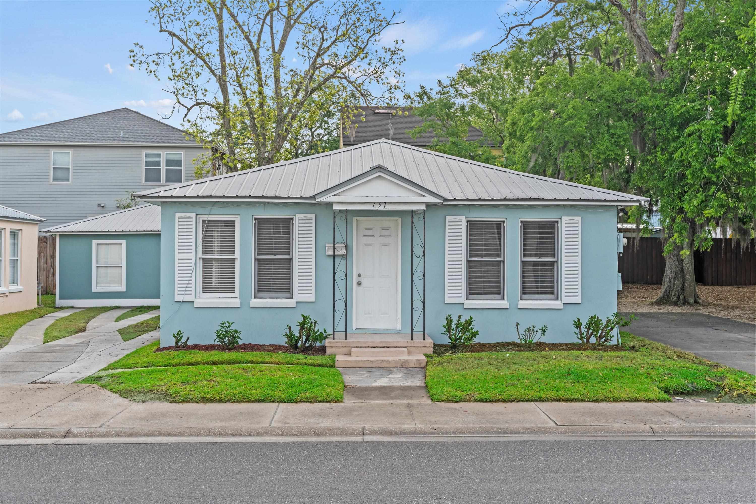 137 A Riberia Street St. Augustine, FL 32084 - Photo 1 of 21 a front view of a house with a yard and potted plants