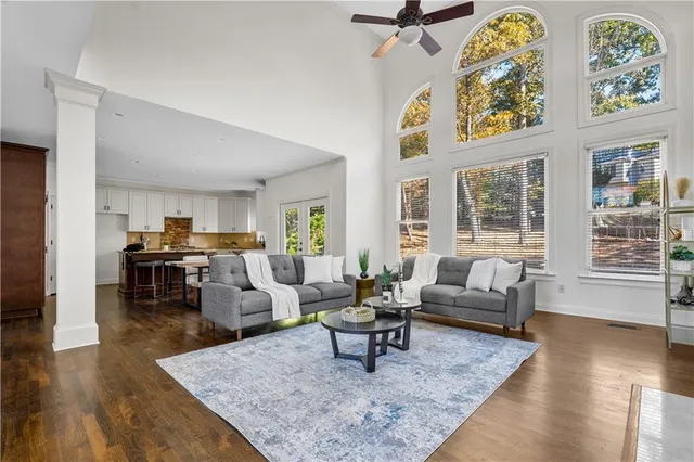 a living room with fireplace furniture and wooden floor