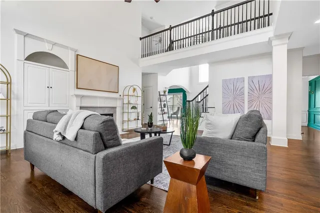 a living room with furniture and wooden floor