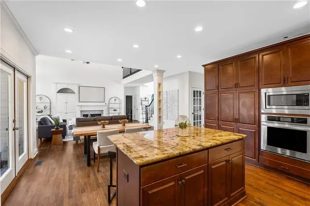 a kitchen with stainless steel appliances granite countertop a stove refrigerator and cabinets