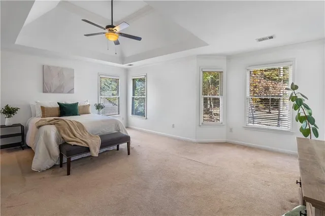 a bedroom with a bed chandelier and window