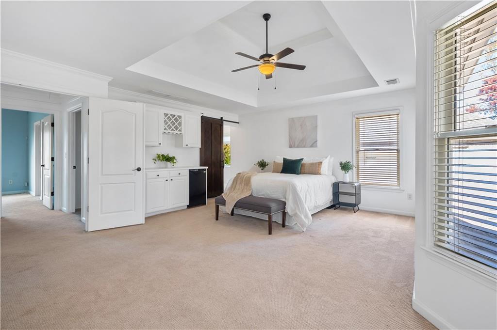 3713 Lake Edge Drive Suwanee, GA 30024 - Photo 19 of 50 a bedroom with a bed and a chandelier