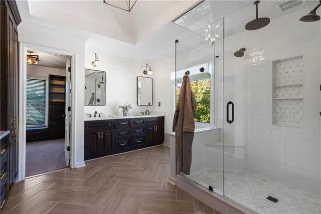 a bathroom with a shower sink and mirror