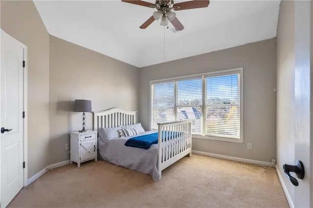 a view of a bedroom with furniture and window