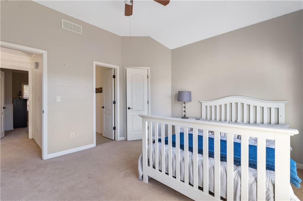 3713 Lake Edge Drive Suwanee, GA 30024 - Photo 31 of 50 a view of a bedroom with furniture and window