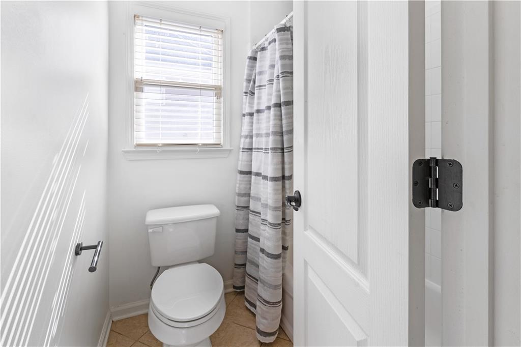3713 Lake Edge Drive Suwanee, GA 30024 - Photo 34 of 50 a white toilet sitting next to a bathroom sink