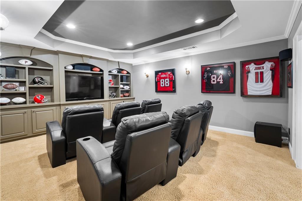 3713 Lake Edge Drive Suwanee, GA 30024 - Photo 40 of 50 a living room with furniture and a flat screen tv