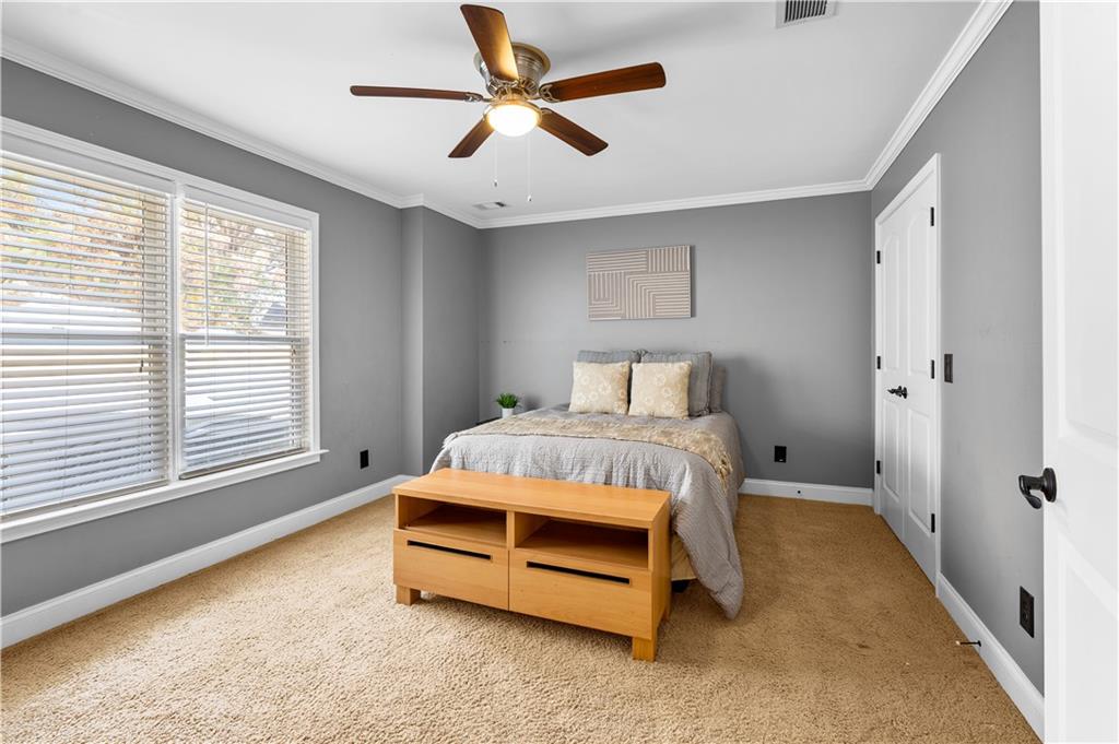 3713 Lake Edge Drive Suwanee, GA 30024 - Photo 42 of 50 a bedroom with a bed and a large window