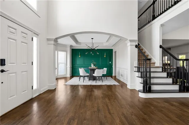a view of a livingroom with wooden floor and furniture