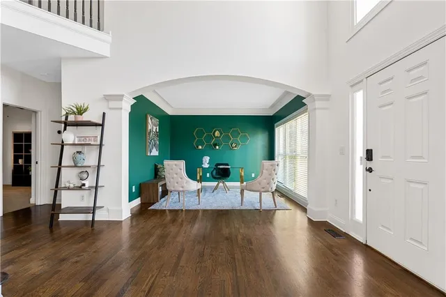a living room with furniture and wooden floor