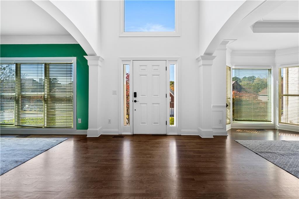 3713 Lake Edge Drive Suwanee, GA 30024 - Photo 9 of 50 an empty room with wooden floor and windows