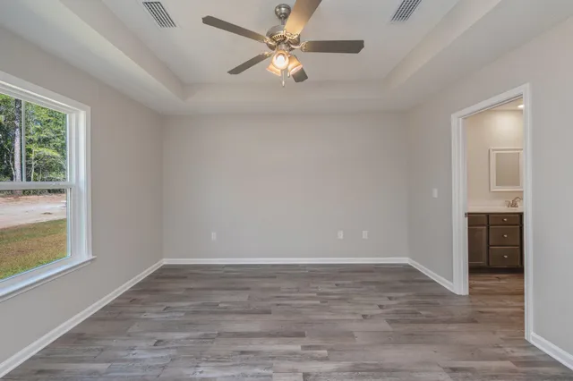 wooden floor in an empty room with a window
