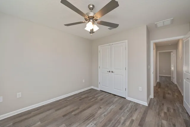 a view of an empty room with wooden floor
