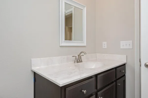 a bathroom with a sink vanity and a mirror
